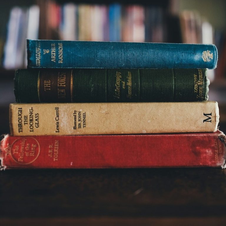 Ein Stapel aus 5 alten Büchern, darunter Lord of the Rings von J.R.R. Tolkien.